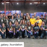 la-food-bank_my-favorite-meal-Wefeedla-5-180x180 A group of people wearing matching shirts and some with gloves are posing inside a warehouse with stacked boxes. They appear to be participating in a volunteer event at the Los Angeles Regional Food Bank, dedicated to helping the community.