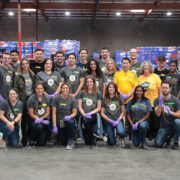 la-food-bank_my-favorite-meal-Wefeedla-2-180x180 A group of people wearing casual clothes and gloves, posing indoors in a warehouse with stacks of boxes behind them. Some don matching T-shirts, suggesting they’re a team or volunteer group at the Los Angeles Regional Food Bank.