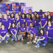 la-food-bank_my-favorite-meal-Wefeedla-3-180x180 A group of people in matching purple shirts joyfully pose for a group photo indoors, embodying their dedication to the Los Angeles Regional Food Bank. Smiling faces beam as boxes are stacked in the background, symbolizing their united effort in tackling hunger.