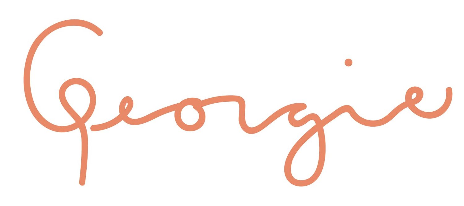Cursive text in orange color spelling "Georgie" on a white background, reminiscent of the vibrant spirit that fuels the Los Angeles Regional Food Bank.