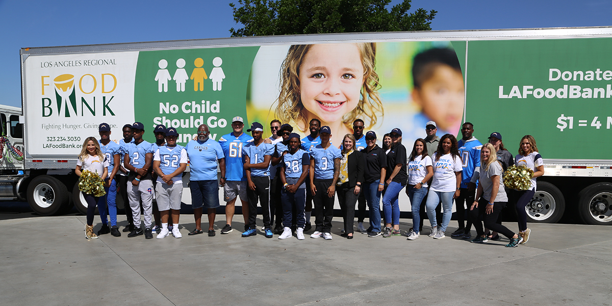 group photo of volunteers in front of truck