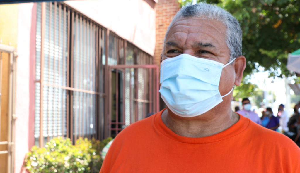 A close up of a volunteer wearing orange at a LA Regional Food Bank partner agency in West Los Angeles.