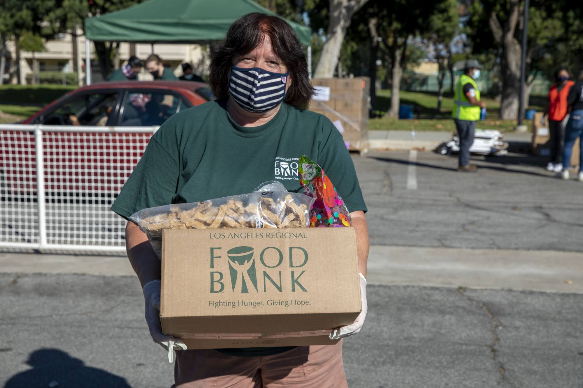 211111-Cudahy-4194 Volunteer Mary Connors holding a food box