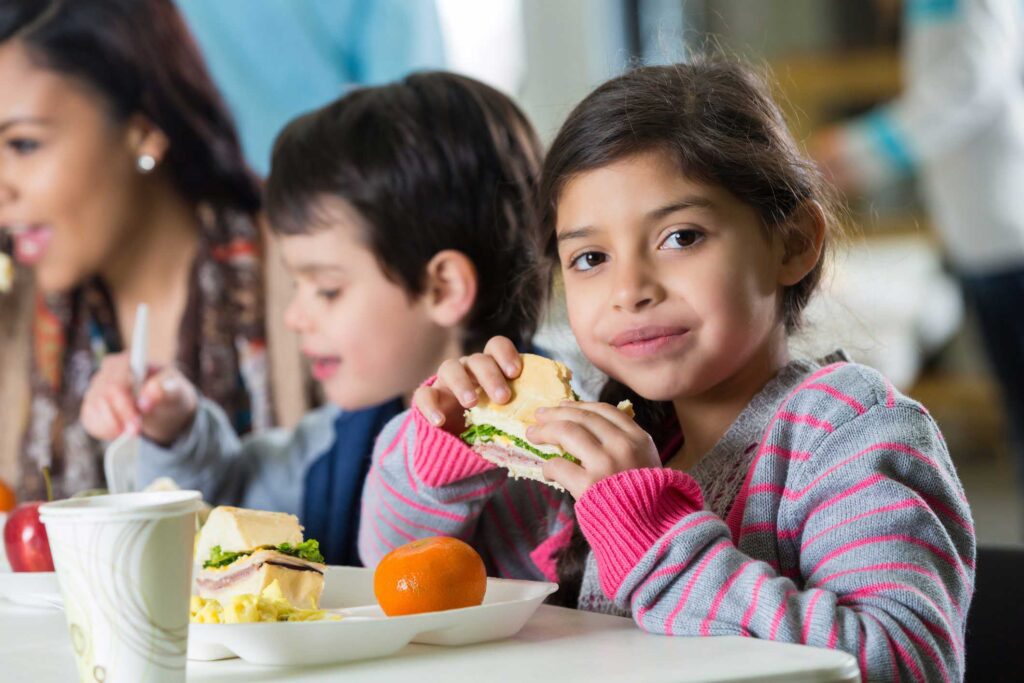 los-angeles-regional-food-bank-giving-tuesday-2023-popup young girl eating lunch