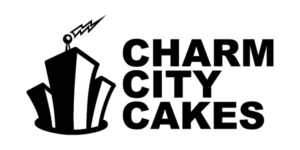 BOB-Party-2017-CharmCityCakes-logo The logo of Charm City Cakes showcases a stylized black and white skyscraper with a small lightning bolt on top, placed beside bold, black letters spelling "Charm City Cakes." The green background subtly nods to community efforts like those of the Los Angeles Regional Food Bank.